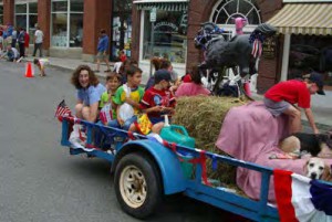 Department chair Antonia Foias (at end of trailer, in blue) with her two sons during Williamstown's July 4 parade on Spring Street.